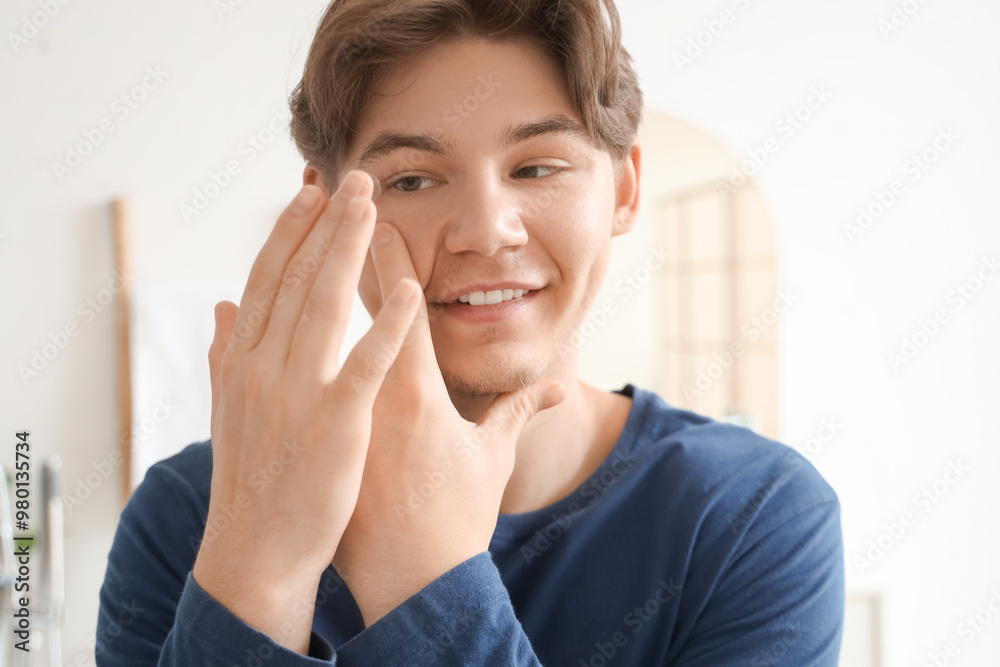 Young man putting contact lenses in bathroom, closeup Young man putting contact lenses in bathroom, closeup