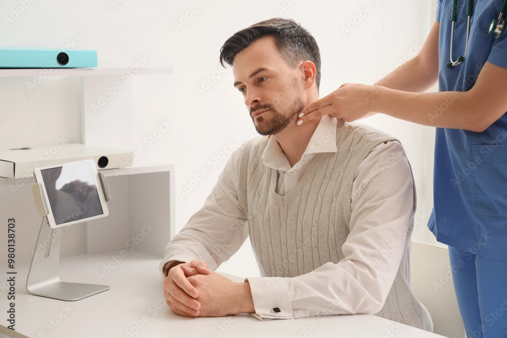 Female doctor checking man's pulse in clinic Female doctor checking man's pulse in clinic