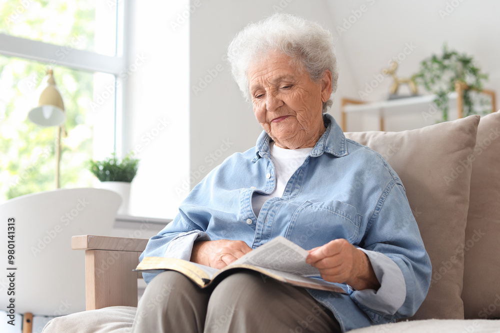 Senior woman on sofa reading Bible at home Senior woman on sofa reading Bible at home