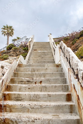 Stairs to a cloudy sky by the beach