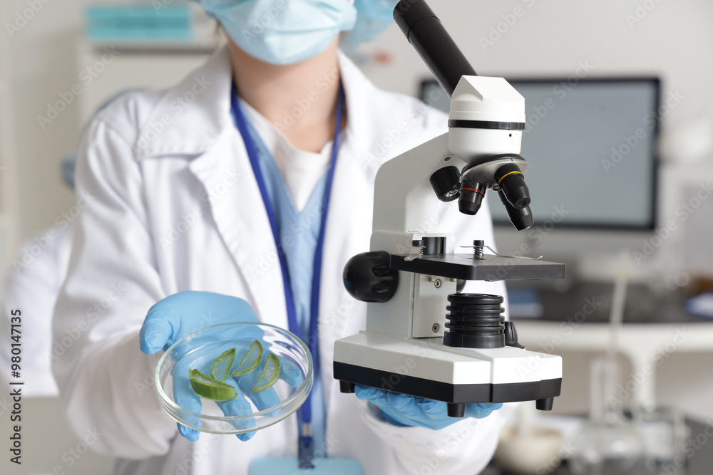 Female scientist with Petri dish and microscope in laboratory, closeup Female scientist with Petri dish and microscope in laboratory, closeup
