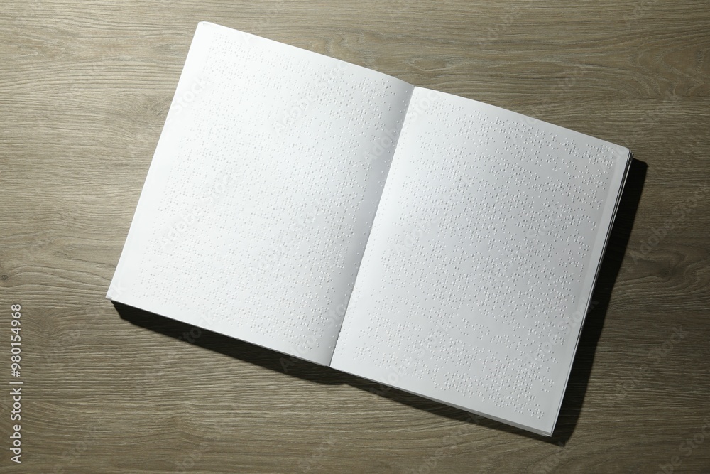 Book with Braille text on wooden table, top view. Education and leisure for blind people Book with Braille text on wooden table, top view. Education and leisure for blind people