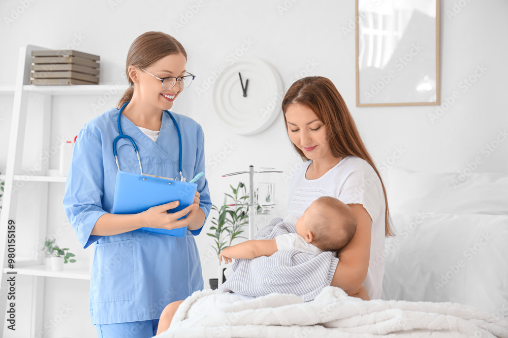 Obraz premium Young mother with newborn baby and nurse in maternity hospital