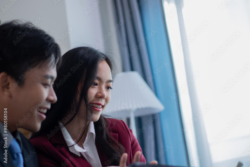 A business couple analyzes the cost of a company's bracelets. A business couple analyzes the cost of a company's bracelets.