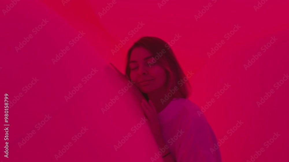 Attractive Woman dreaming in Dynamic Ambient Light Environments artistic space with a colourful lighting soft balls that change their colors Attractive Woman dreaming in Dynamic Ambient Light Environments artistic space with a colourful lighting soft balls that change their colors