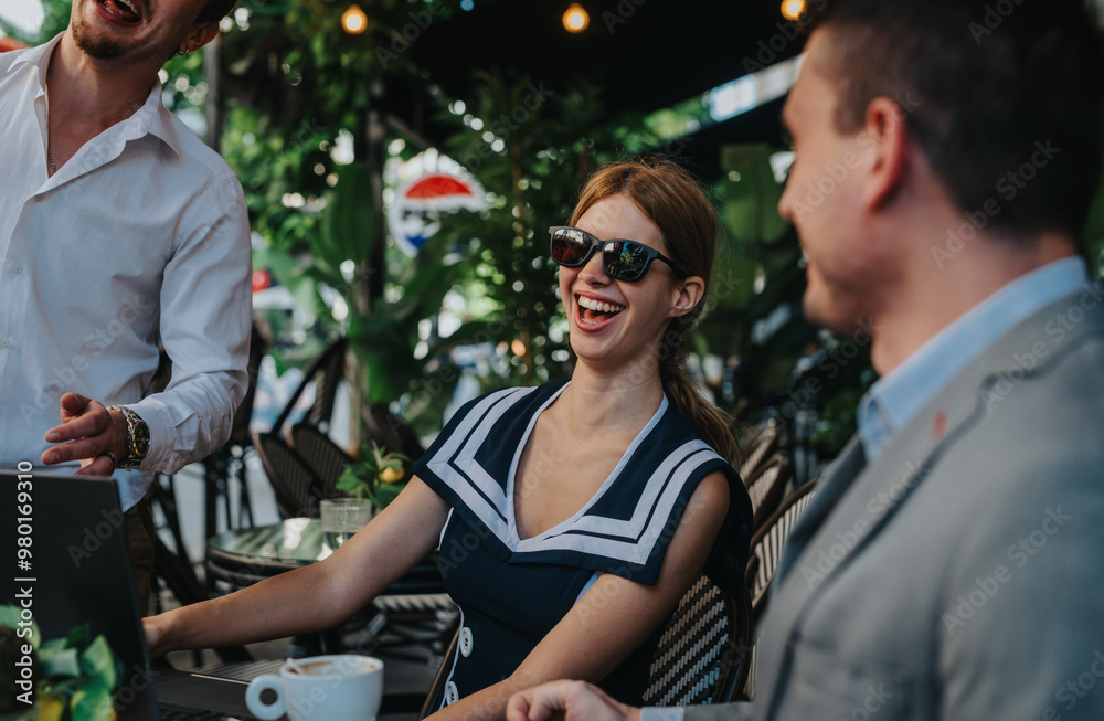 Fototapeta premium Group of businesspeople enjoying a vibrant meeting at an outdoor cafe, sharing laughter and ideas in a relaxed setting.