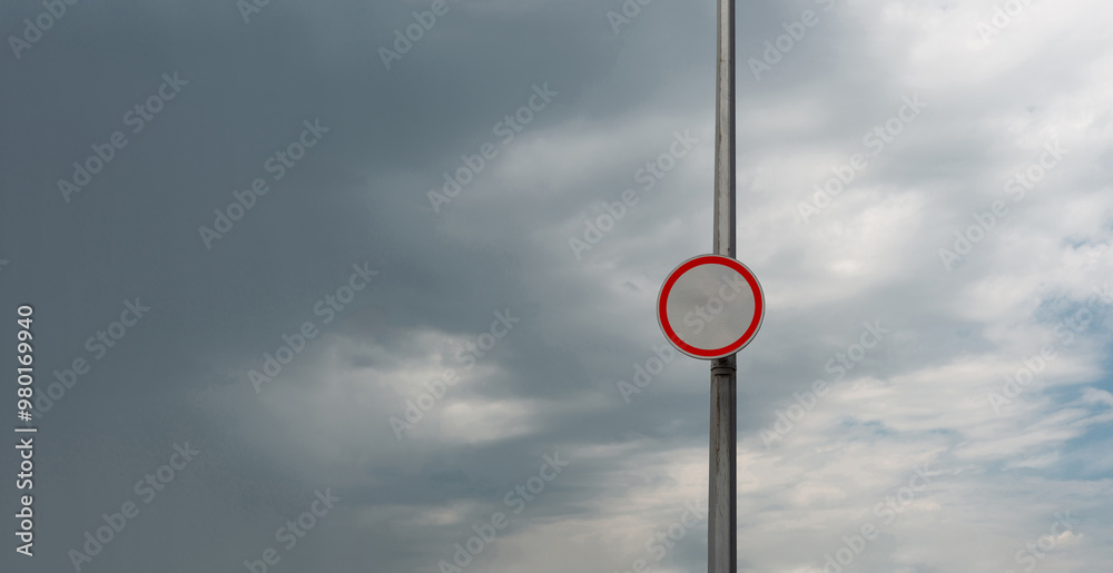 Blank Round Traffic Sign on Pillar with Cloudy Sky Background. Blank Round Traffic Sign on Pillar with Cloudy Sky Background.