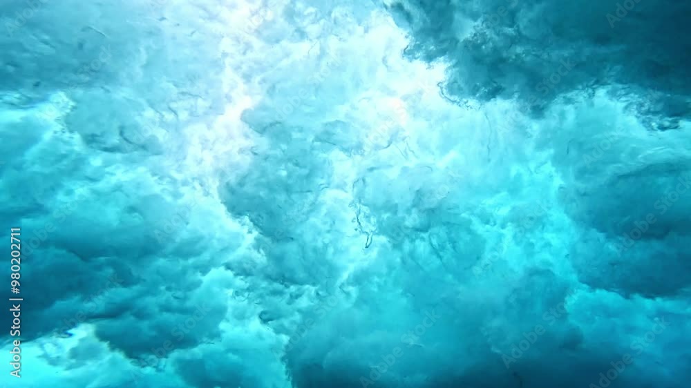 Ocean wave. Underwater view of clear ocean wave breaking over corral reef. spinning vortex, clouds. powerful nature, strong wave, danger of drowning. slow motion. Ocean wave. Underwater view of clear ocean wave breaking over corral reef. spinning vortex, clouds. powerful nature, strong wave, danger of drowning. slow motion.