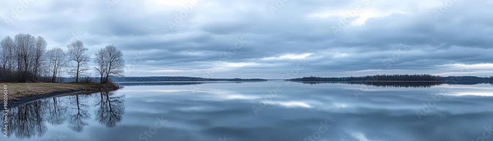 A calm, overcast day by the lake, with grey clouds reflected in the still water, creating a moody, tranquil scene, soft lighting, cool tones, serene atmosphere A calm, overcast day by the lake, with grey clouds reflected in the still water, creating a moody, tranquil scene, soft lighting, cool tones, serene atmosphere