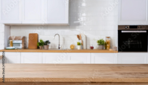 Blurred view of modern kitchen with white furniture with wooden table