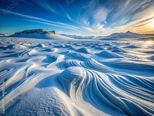 Intricate patterns of drifted snow swirl across the frozen landscape, sculpted by fierce winds, under the pale blue morning light of Berlevåg, Norway's Arctic wilderness.