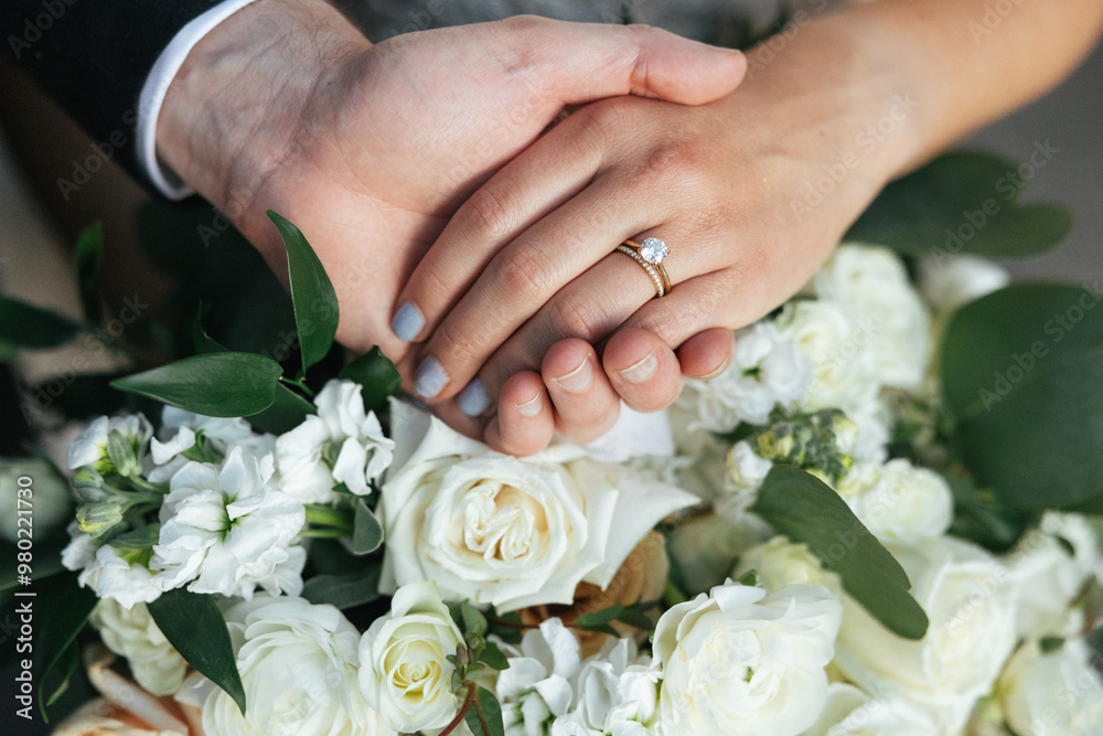 Closeup of bride and grooms hands on flowers. Closeup of bride and grooms hands on flowers.