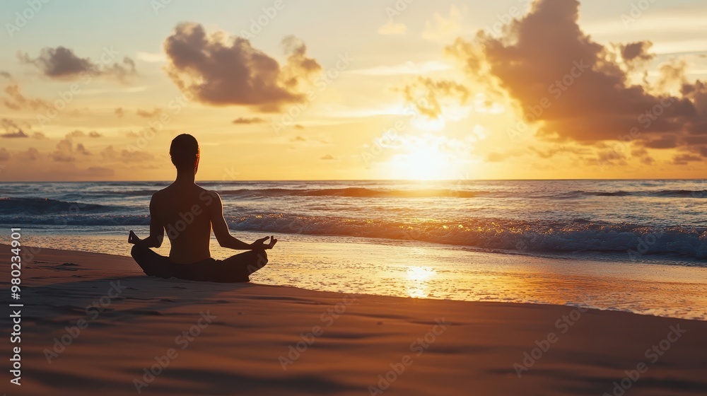 Silhouette of a Man Meditating on a Beach at Sunset Silhouette of a Man Meditating on a Beach at Sunset