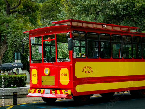 Bonito autobús rojo y amarillo en un parque, listo para llevar gente a pasear en la ciudad de México