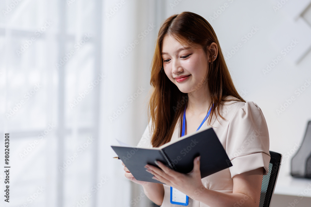 Young happy woman work on laptop, asian female reading financial document report or learning online education and business concept.
Young happy woman work on laptop, asian female reading financial document report or learning online education and business concept.