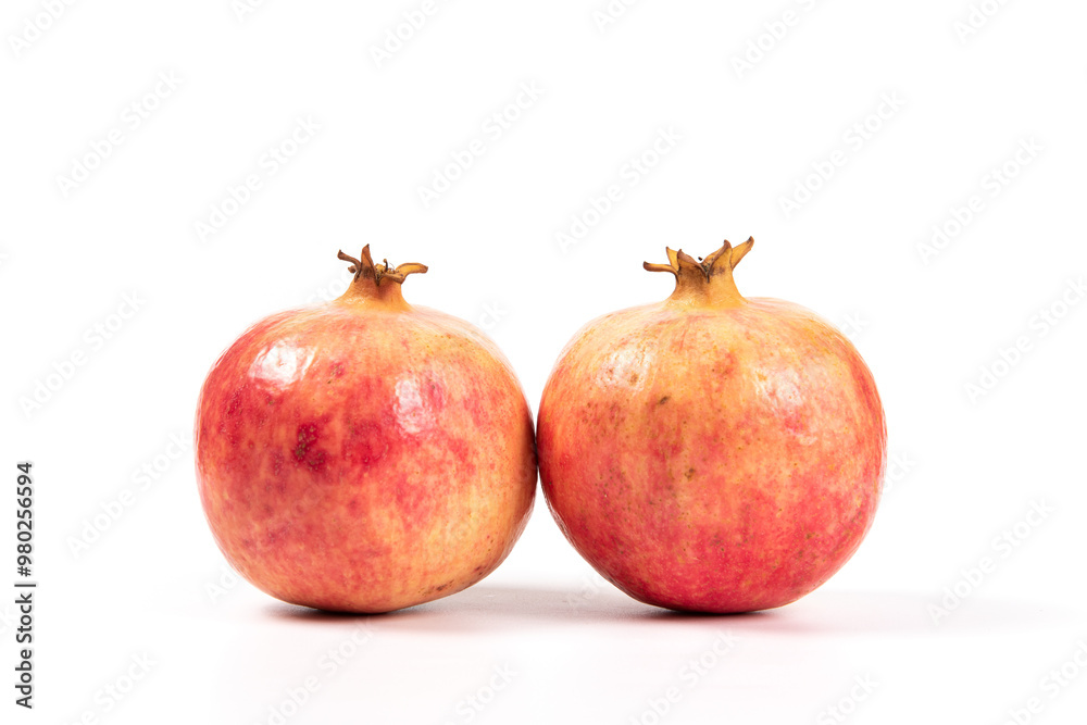 whole pomegranates isolated on white background. whole pomegranates isolated on white background.
