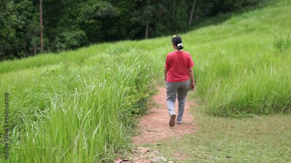 Asia women walking on the meadow Asia women walking on the meadow