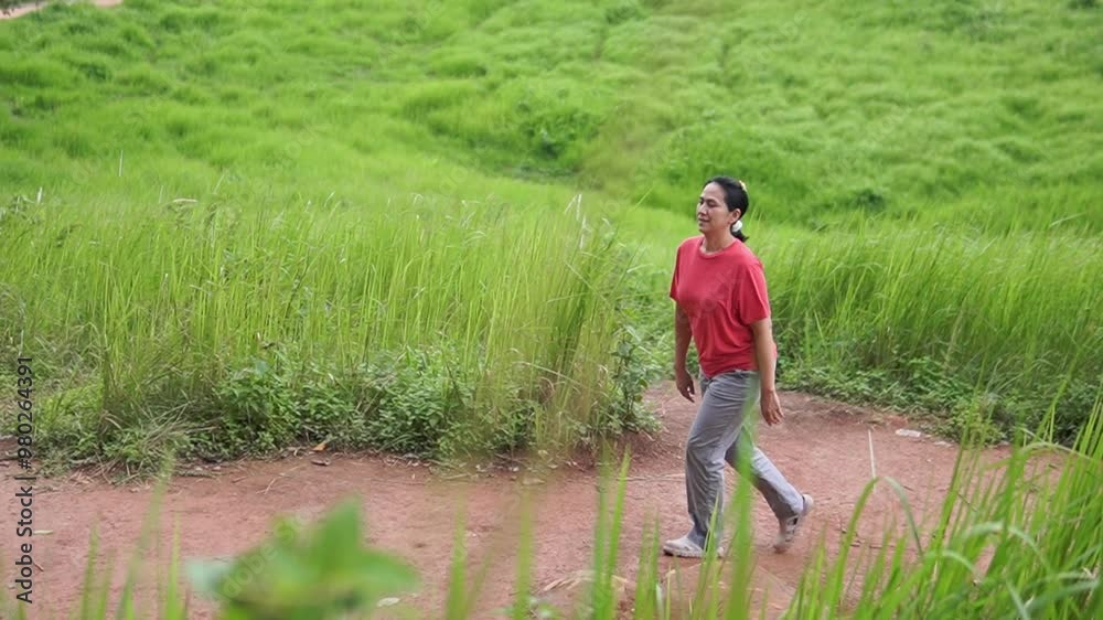 Asia women walking on the meadow Asia women walking on the meadow
