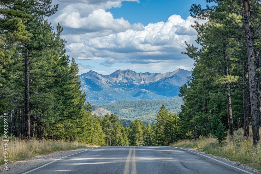 Fototapeta premium Road with a distant view of mountains, pine trees framing the scene, majestic and vast