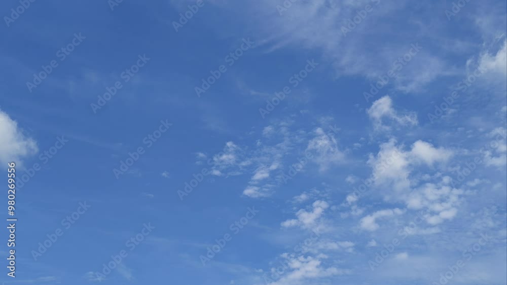 A beautiful blue sky with soft white clouds against an abstract background A beautiful blue sky with soft white clouds against an abstract background