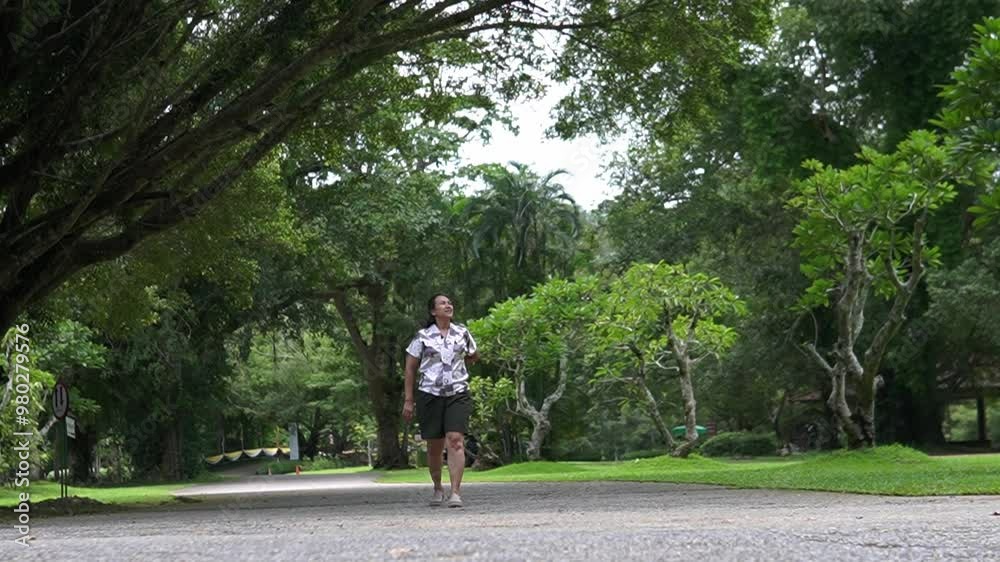 Asian woman walking along the river in the forest Asian woman walking along the river in the forest