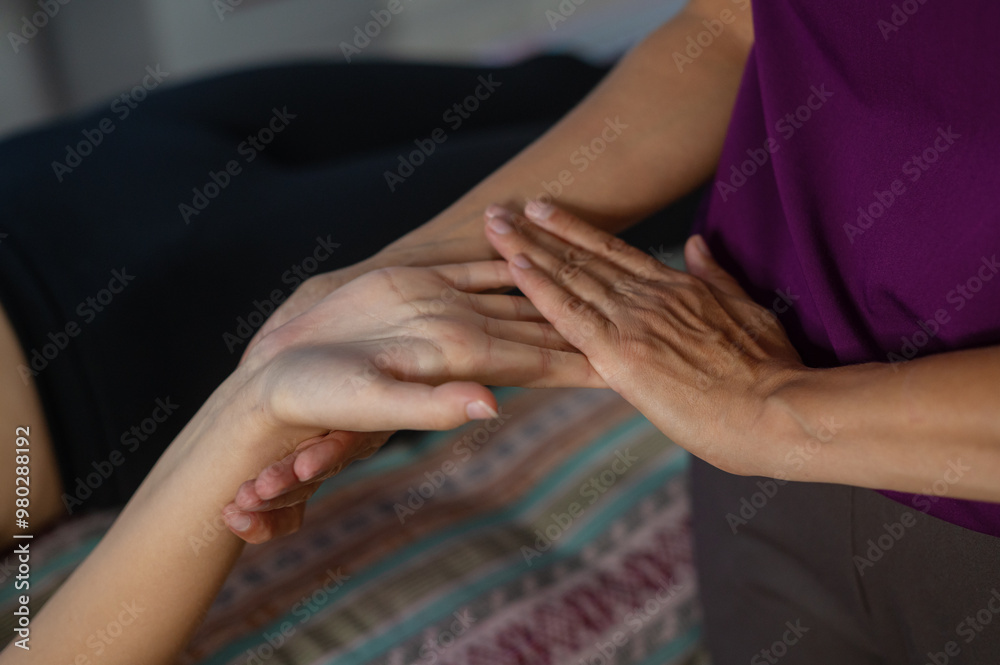Obraz premium The massage therapist's beautiful tanned hands do a wellness massage. Health and beauty. Massage parlour. Myofascial release.