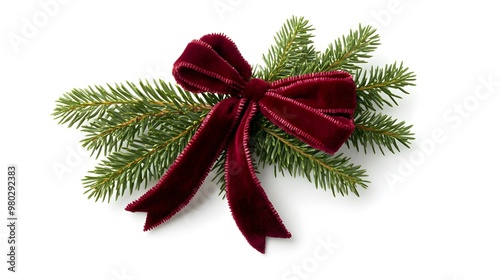 A single red velvet bow tied around a sprig of pine needles, isolated against a white background.