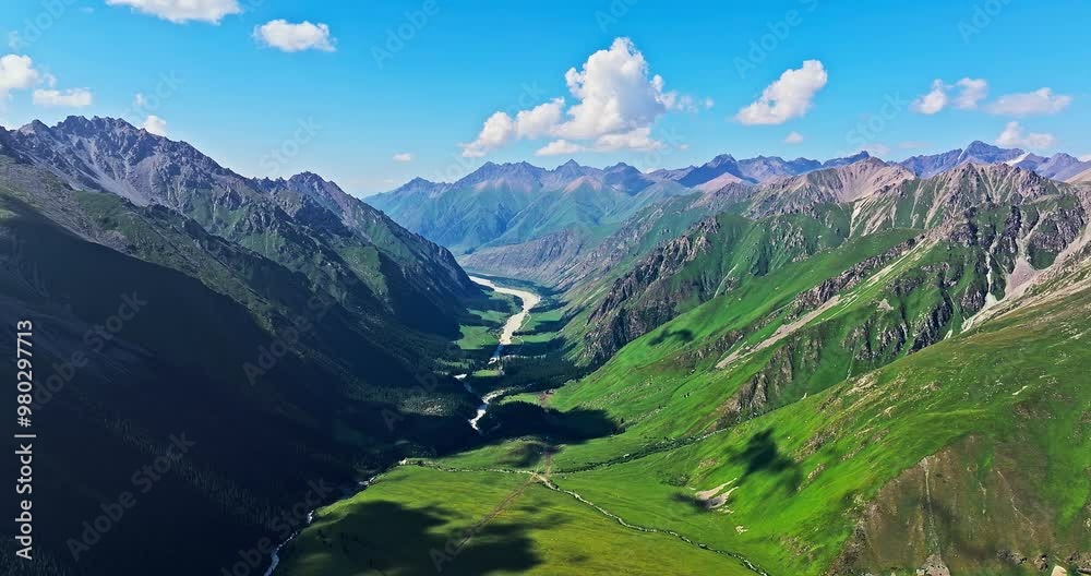 Aerial view of green meadows and valley with mountain nature landscape in summer. Beautiful mountain range scenery in Xinjiang, China. Aerial view of green meadows and valley with mountain nature landscape in summer. Beautiful mountain range scenery in Xinjiang, China.