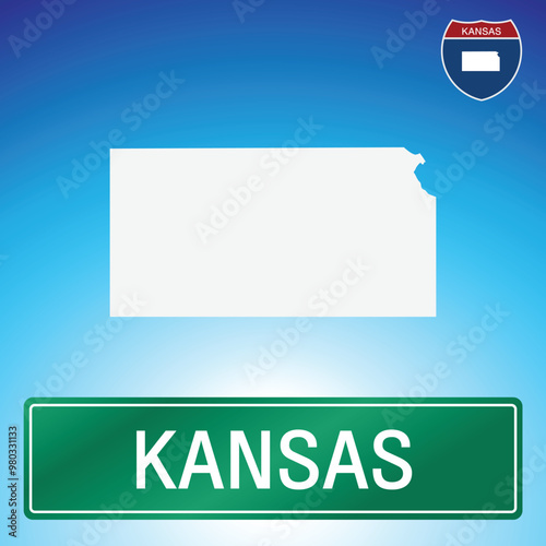 A simple road sign for Kansas with a map of the state in the background. The sign is green with white lettering, and the map is white with a blue gradient background.