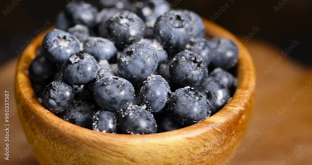 blueberries in a bowl with white sugar, sprinkled with white sweet sugar juicy blueberry berries