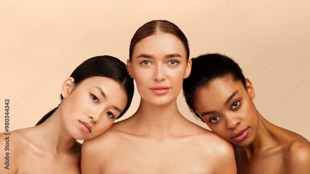Female Beauty. Three Multiracial Women Looking At Camera Posing In Studio On White Background. Isolated, Panorama Female Beauty. Three Multiracial Women Looking At Camera Posing In Studio On White Background. Isolated, Panorama