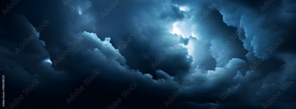 Naklejka premium Dark and moody clouds covering the sky in a dramatic cloudscape background, stormy, overcast, weather, atmospheric, dramatic