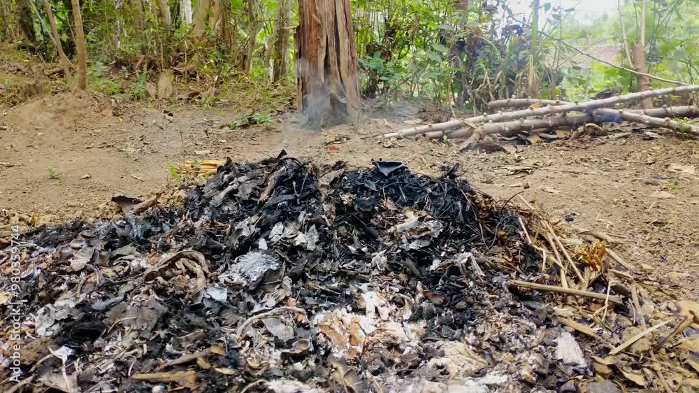 Ashes from dry leaves that are burned and still emit smoke. Ashes from dry leaves that are burned and still emit smoke.