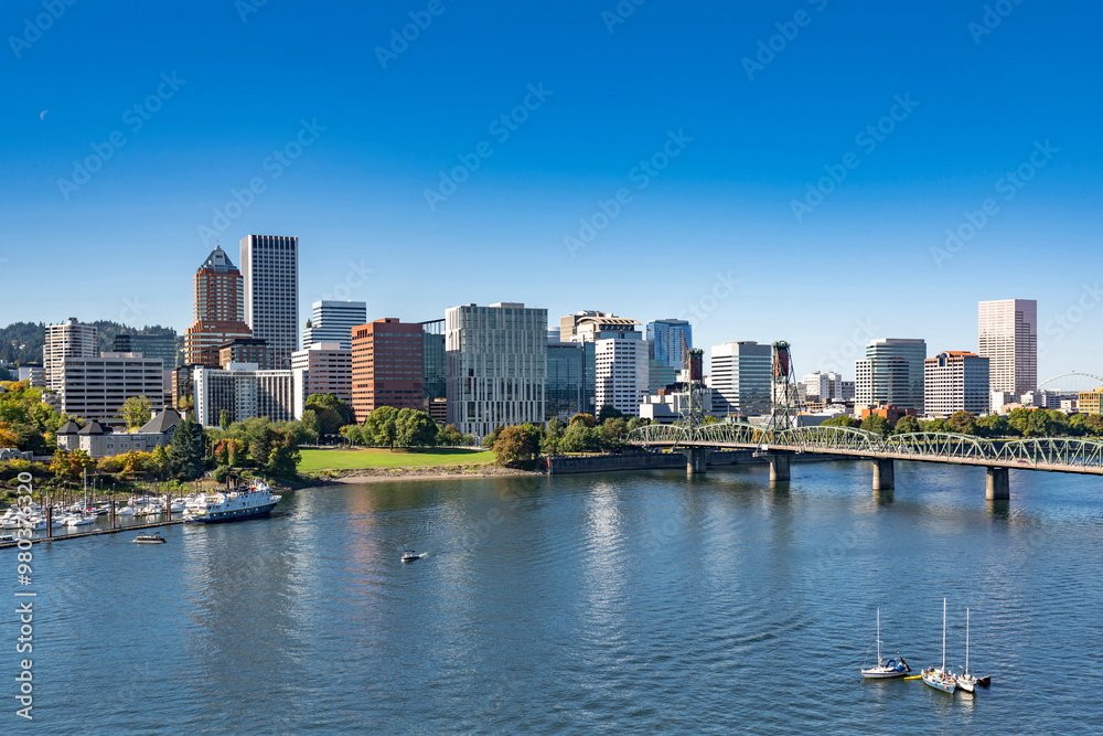 Fototapeta premium Portland Downtown with office and residential high-rise buildings on the waterfront of the Willamette River with a marina and an arched drawbridge over the river