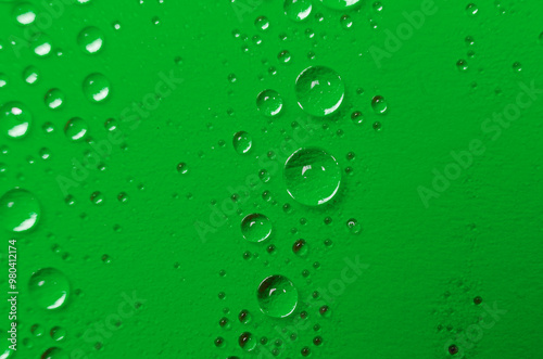 Close up or macro photography of water droplets on dark green cover background. Water droplets and wallpaper concept