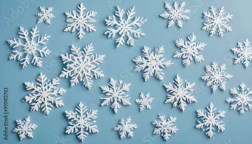 Assorted snowflake decorations on a light blue background.