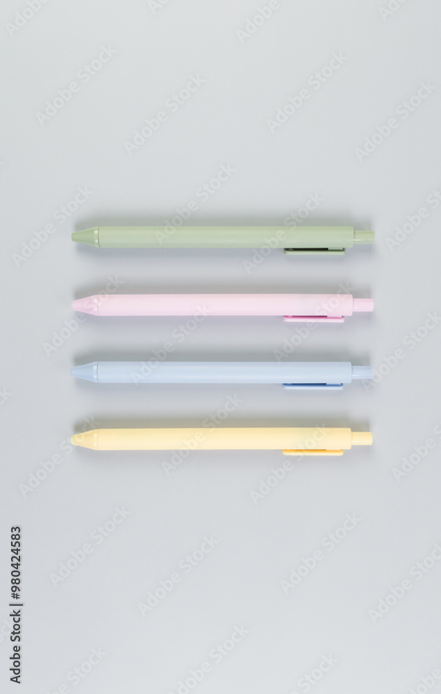 Top view of colorful pens on grey background. School, office wallpaper. Flat lay, copy space. Top view of colorful pens on grey background. School, office wallpaper. Flat lay, copy space.