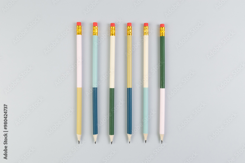 Fototapeta premium Top view of colorful pencils on grey background. School, office, art wallpaper. Flat lay, copy space.