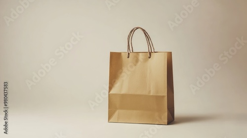 Minimal paper shopping bag set against a blank background, highlighting its simplicity and functional design. No logo, no people. photo