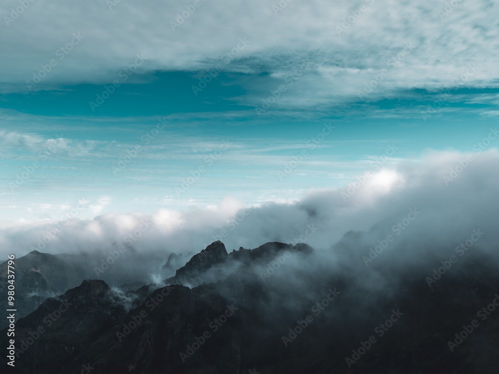Dramatic sky with cloud and fog over the mountains. Was a cloudy day in the top of the hill, with some clearings between the clouds, in Madeira, Portugal Dramatic sky with cloud and fog over the mountains. Was a cloudy day in the top of the hill, with some clearings between the clouds, in Madeira, Portugal