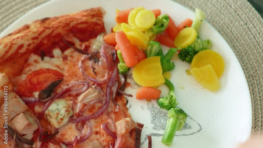 delicious appetizing pizza with meat and cheese lies in a plate with vegetables. Healthy or unhealthy food. Fresh healthy carrots, greens, broccoli, cabbage delicious appetizing pizza with meat and cheese lies in a plate with vegetables. Healthy or unhealthy food. Fresh healthy carrots, greens, broccoli, cabbage