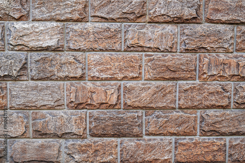 Naklejka premium Brown brick blocks, brickwork. the texture of the wall.