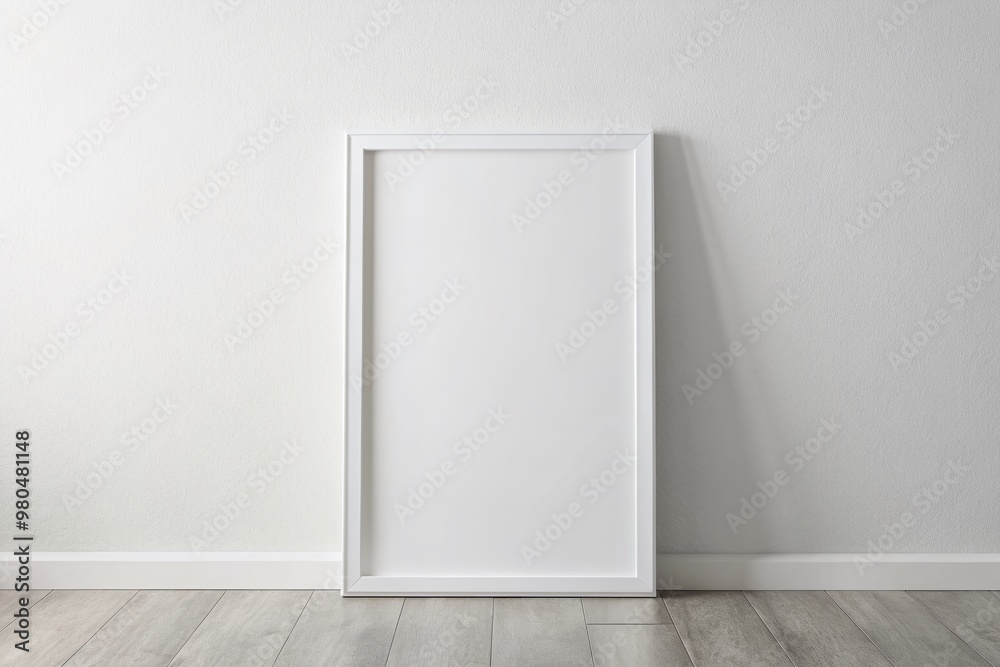 White rectangular vertical frame hanging on a white wall mockup White rectangular vertical frame hanging on a white wall mockup
