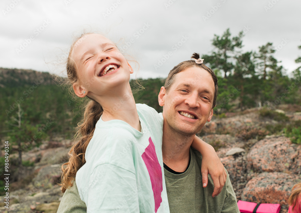 girl sat with her father after playing with his hair whilst hiking girl sat with her father after playing with his hair whilst hiking