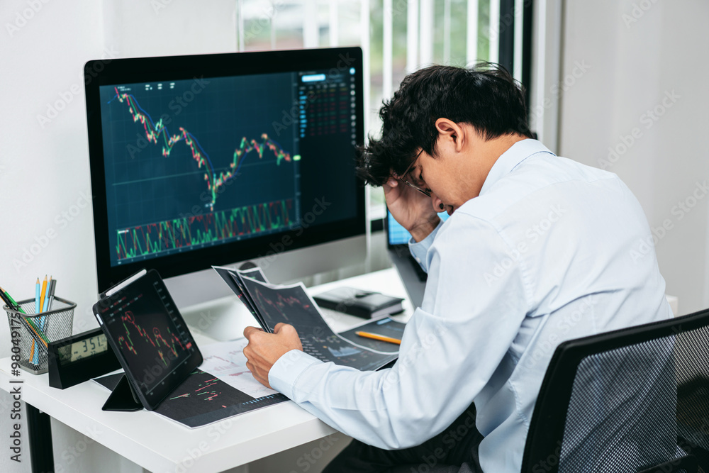 Businessman investor working and stress with computer analyzing graph stock market trading planning with chart data financial investment planning Businessman investor working and stress with computer analyzing graph stock market trading planning with chart data financial investment planning