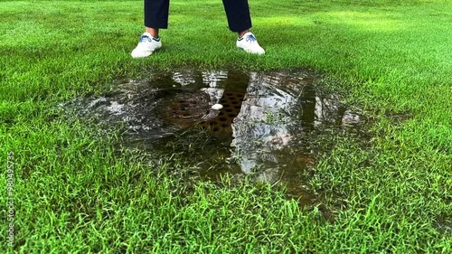 Wallpaper Mural Golfer Hitting the Golf Ball with Her Golf Club in a Water Pond on the Fairway on Golf Course in Switzerland. (Slow Motion) Torontodigital.ca