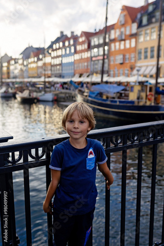 Family with children and pet dog, kids and adults visiting Coppenhagen , capital city of Denmarn during summer photo