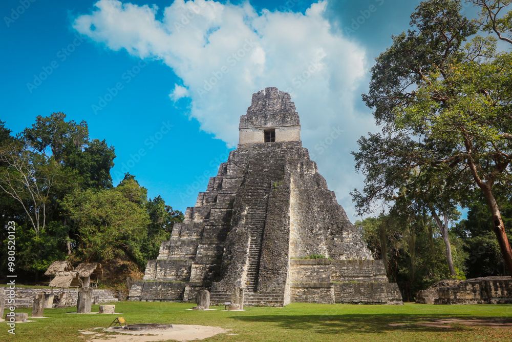 Explore the majestic pyramid of Tikal in Guatemala under a bright blue sky Explore the majestic pyramid of Tikal in Guatemala under a bright blue sky