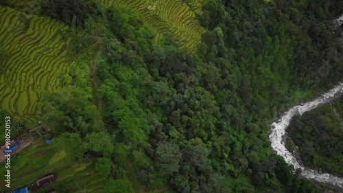 Green paddy fields of Bhojpur Nepal,  small river at the bottom of the village photo