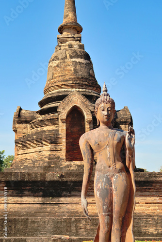 Photography The standing buddha statue in front of a small pagoda next to the Wat Sa Si, Wat